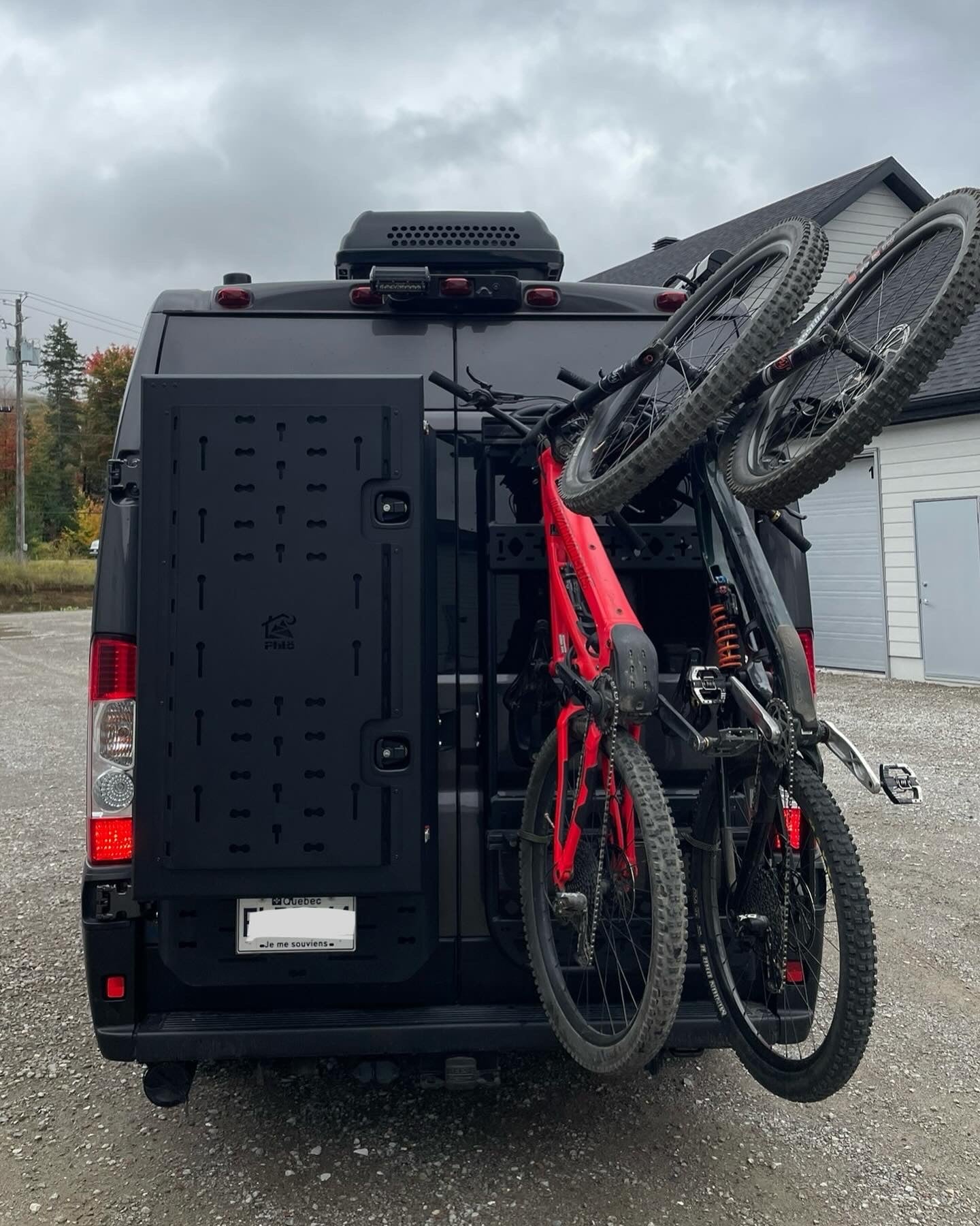 Phlosystem bicycle transport kit with two bicycles mounted on a Ford Transit.