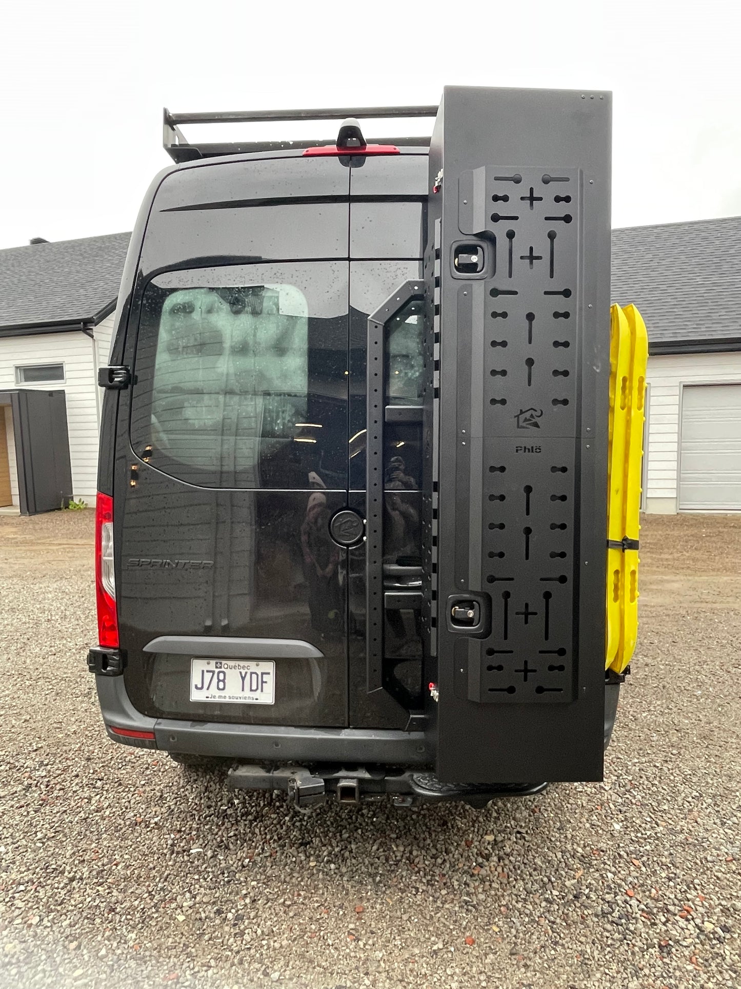 phlosytem ski storage chest installed on the right rear door of a mercedes benz sprinter